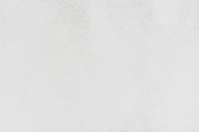 Full frame close up of a fine textured matte white stucco wall surface