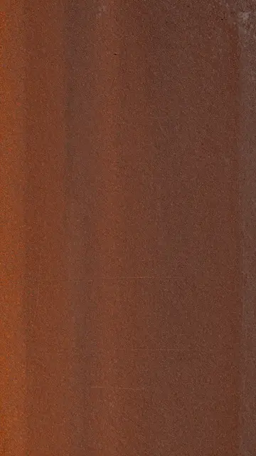 Full frame close-up of a weathered rust-brown metal surface with faint fine scratches and flat even lighting