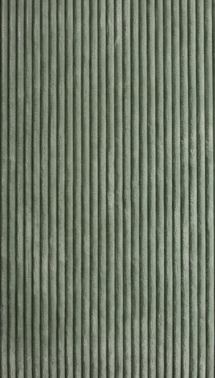Full frame close-up of soft sage green corduroy fabric with evenly spaced vertical ribs