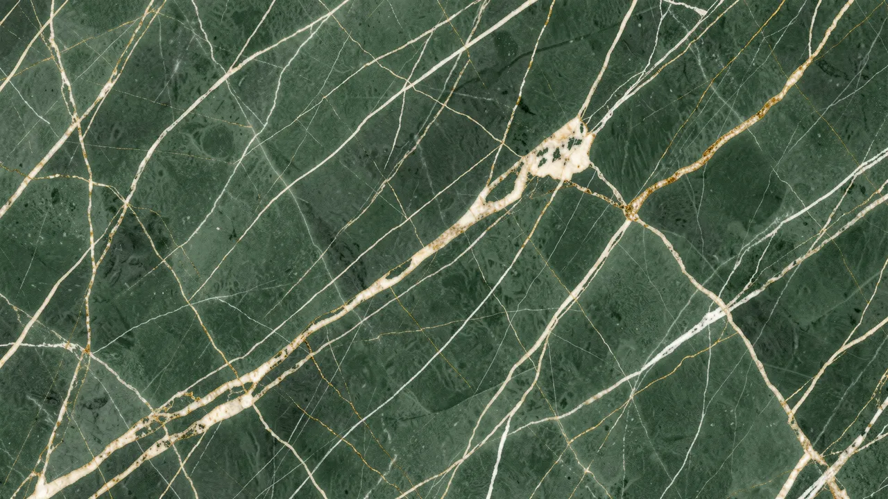 Full frame close-up of sage green marble with thin cream and gold veining spanning the frame