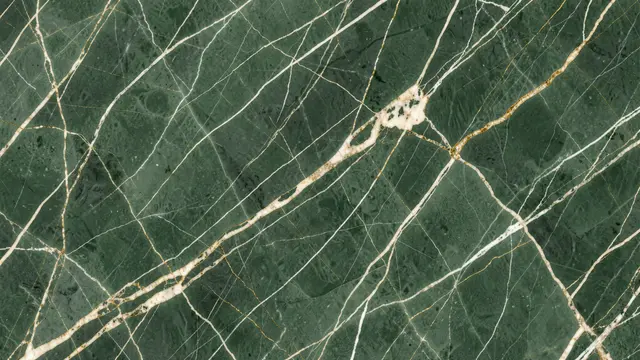Full frame close-up of sage green marble with thin cream and gold veining spanning the frame