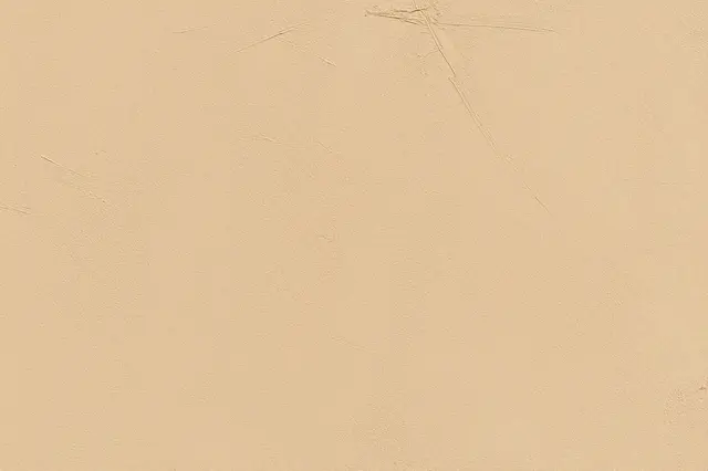 Full frame close-up of a sand-toned limewash wall with subtle faint brush marks