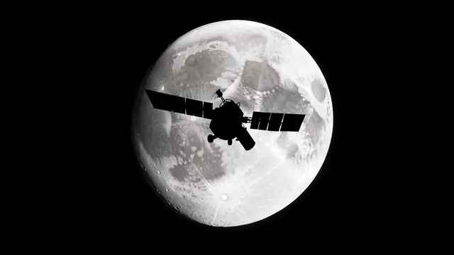 A black satellite silhouette crosses in front of a detailed full moon against a black starless sky