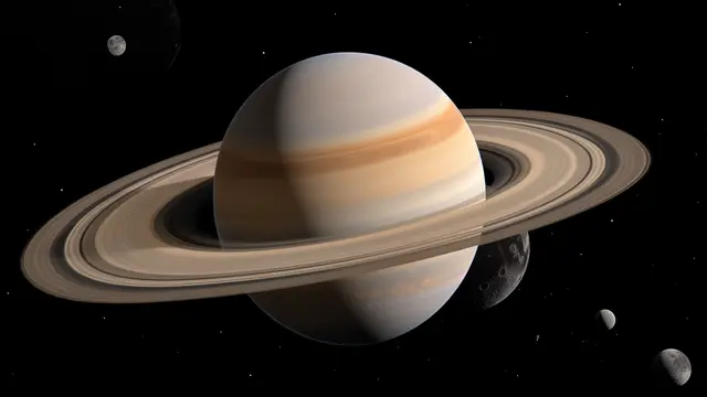 Ringed planet Saturn floats in dark starry space surrounded by smaller orbiting moons