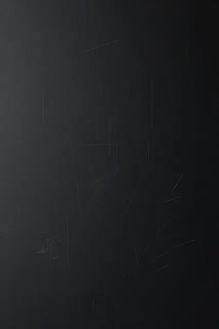 Matte black surface with faint thin chalky white scuff marks and subtle side lighting gradient
