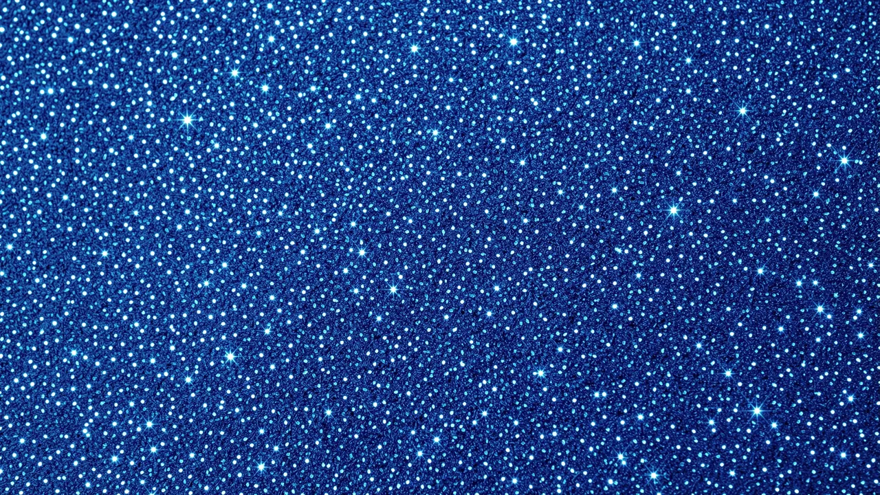 Full frame close-up of a dense deep blue glitter surface with bright sparkling highlights across the entire frame