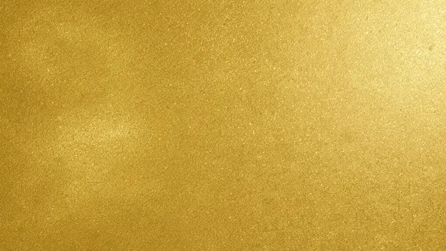 A full frame uniform shimmering warm gold textured surface with subtle light highlights