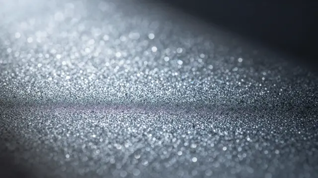 Soft out-of-focus silver and sparkling blue bokeh lights spread across a dark gradient background