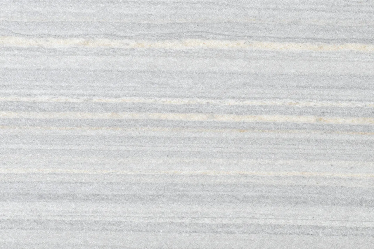 Top view of a flat silver travertine surface with horizontal gray and cream linear bands