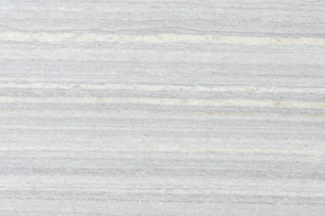 Top view of a flat silver travertine surface with horizontal gray and cream linear bands