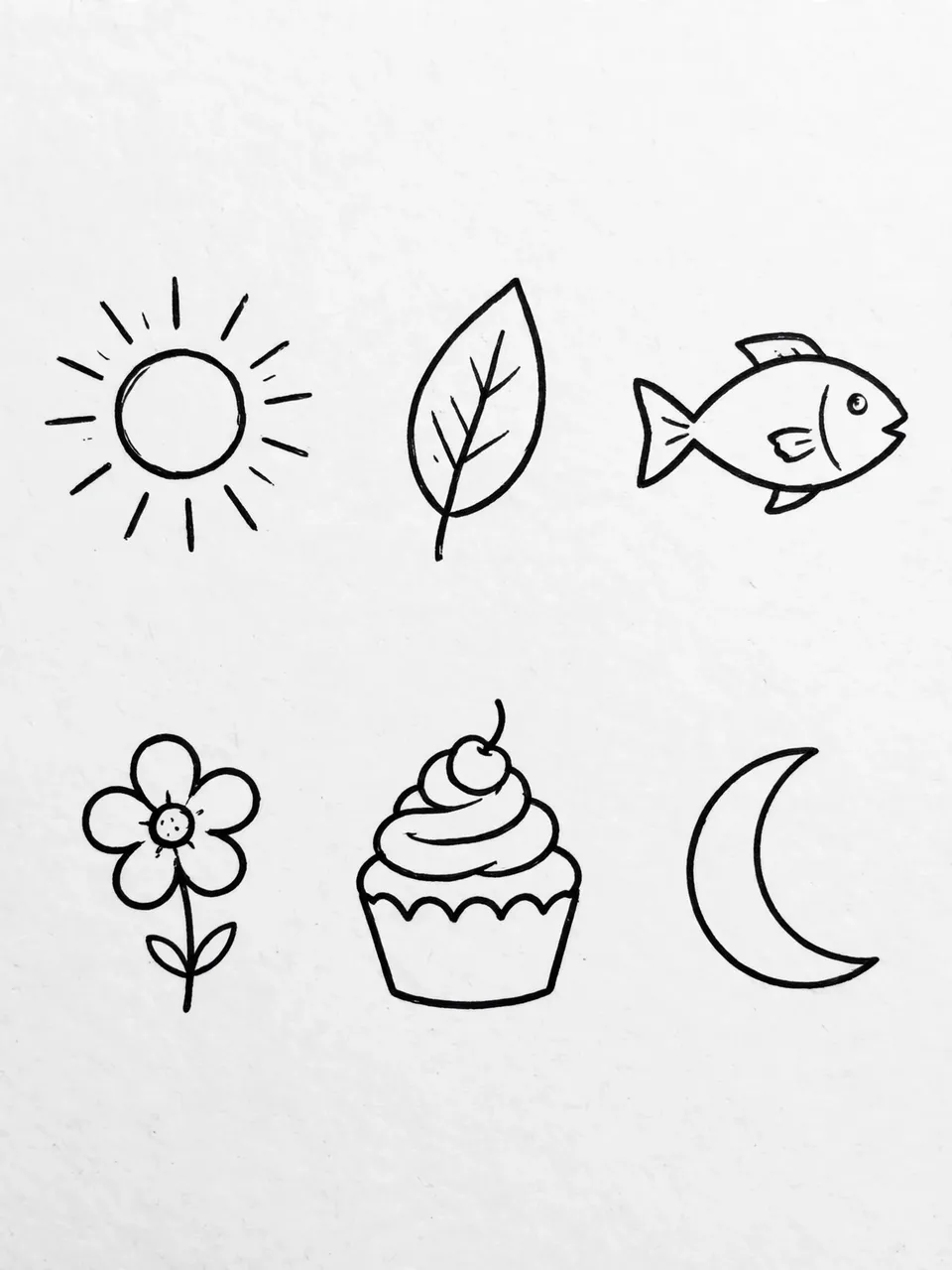 Black line art of six simple doodles: sun, leaf, fish, flower, cupcake, and crescent moon arranged on light gray paper
