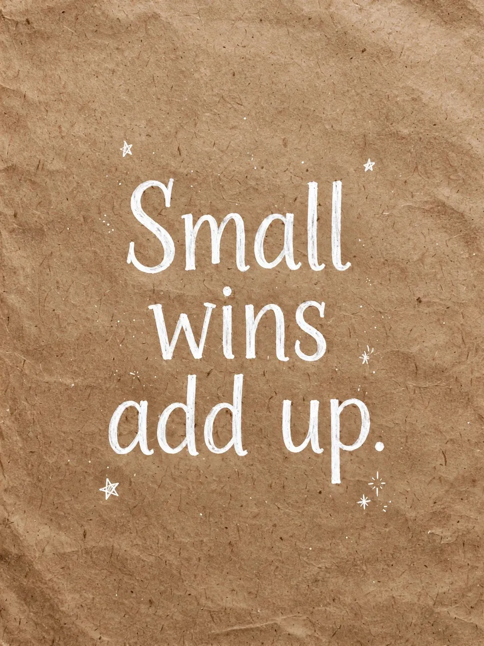 White hand-drawn lettering reading "Small wins add up." with tiny doodled stars on brown crumpled kraft paper