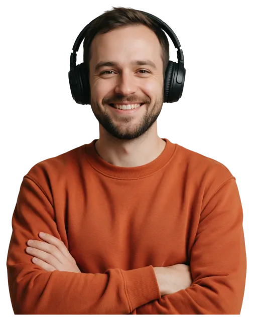 Waist-up portrait of a smiling bearded man with crossed arms and black over-ear headphones
