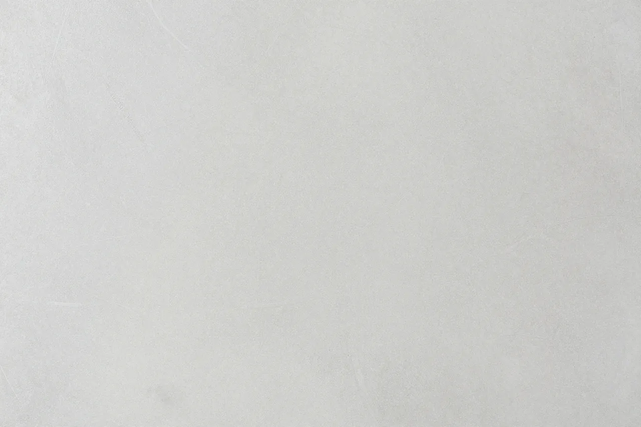 Full frame close-up of a smooth light gray cement surface with faint subtle trowel marks