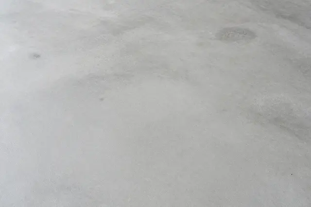 Matte light gray polished concrete floor with subtle natural tonal variations and small surface imperfections