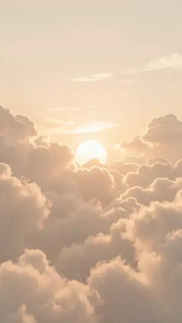 Pale sun peeks through fluffy beige cloud layers in a dreamy vertical dawn sky