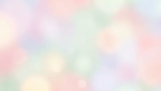 Blurred soft focus pastel background with gentle glowing light leak bokeh highlights