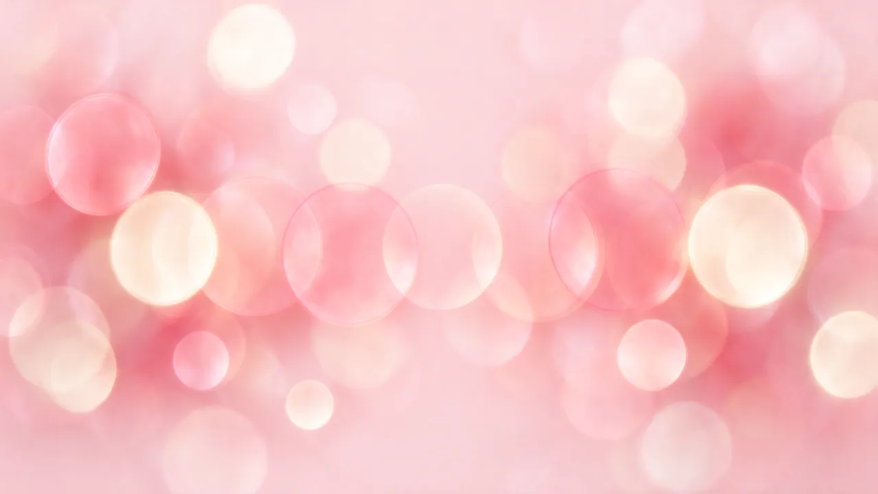 Dreamy defocused rose and cream bokeh circles over a light pink base background