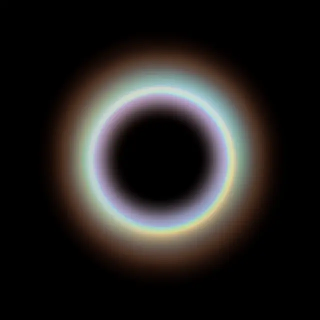 A smooth round halo lens flare with faint rainbow gradient sits centered on a pure black background