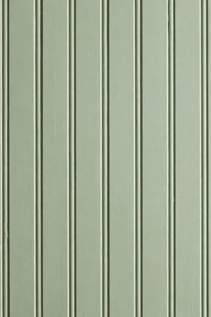 Full frame close-up of matte painted sage green beadboard paneling with vertical grooves