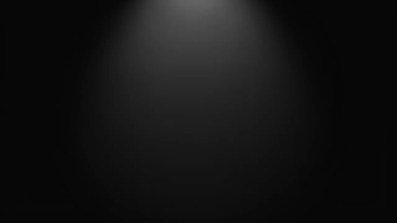 A smooth dark background with a faint soft spotlight gradient centered at the top