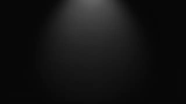 A smooth dark background with a faint soft spotlight gradient centered at the top