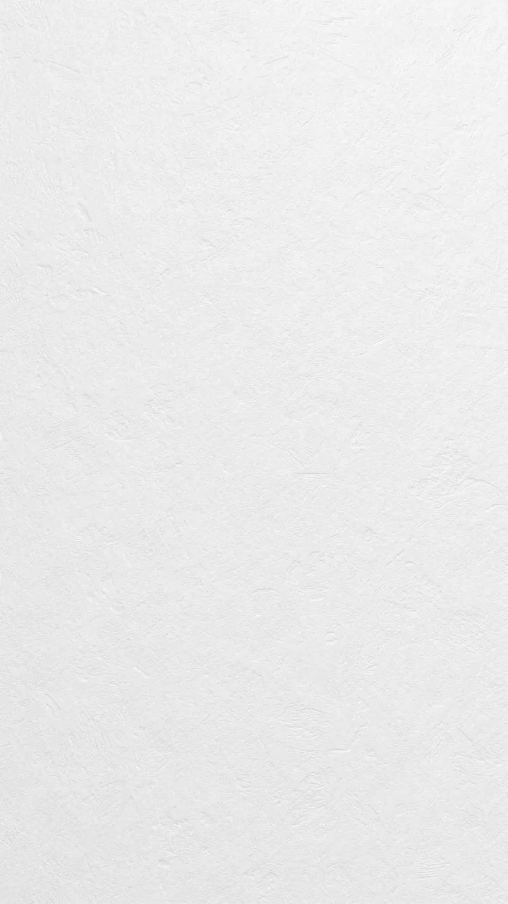 Full frame vertical shot of a subtle textured soft white paper surface