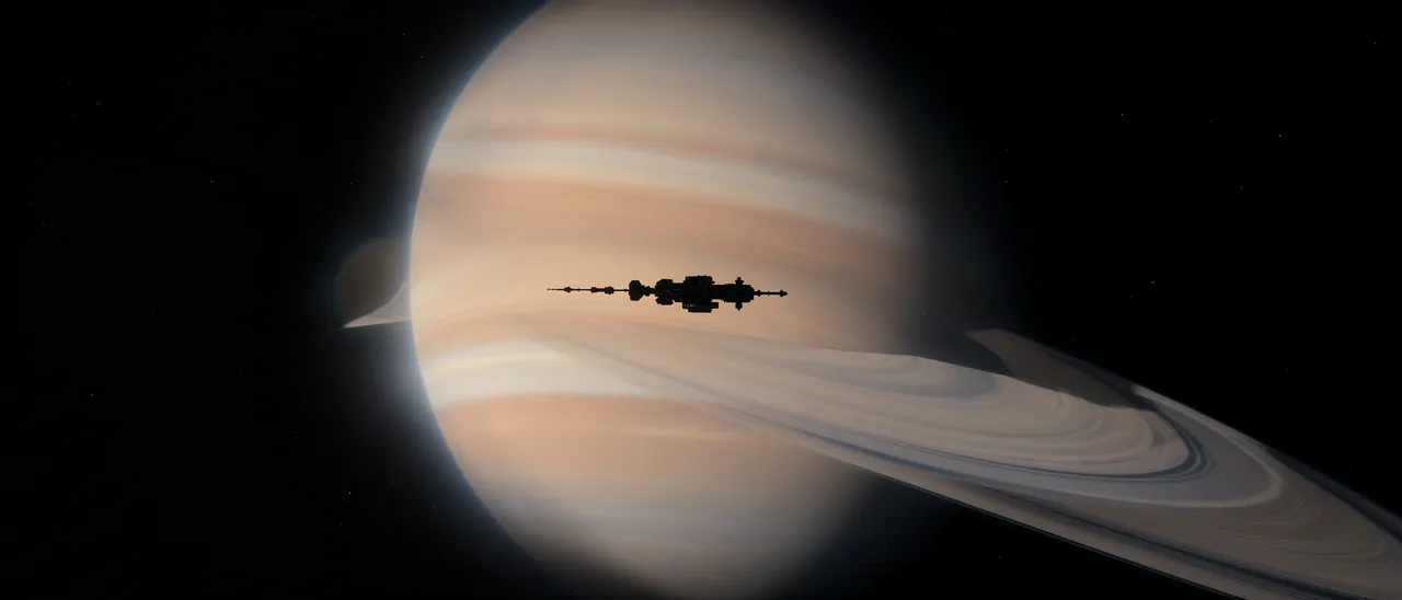 A distant space station silhouette passes in front of a large ringed gas giant against dark outer space