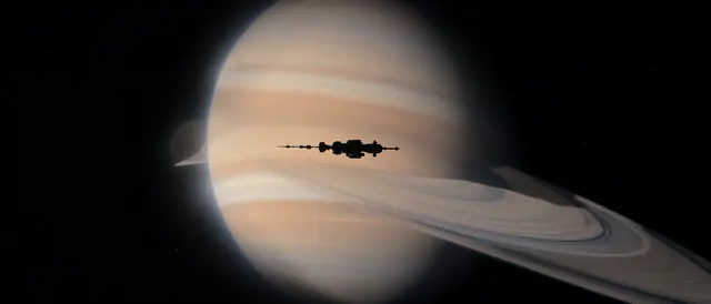 A distant space station silhouette passes in front of a large ringed gas giant against dark outer space