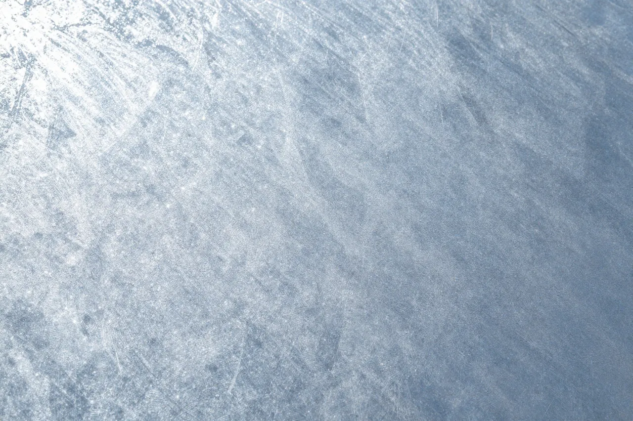 Full frame close-up of a spangled, brushed galvanized steel sheet surface