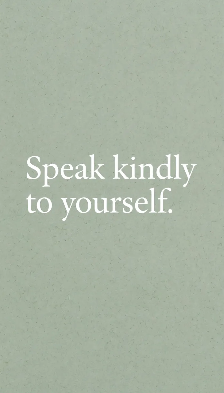 Centered white serif text reading "Speak kindly to yourself." on a soft sage green grainy background