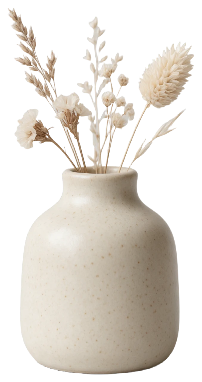 A small speckled cream ceramic vase holding a curated arrangement of dried neutral-toned flowers and grasses