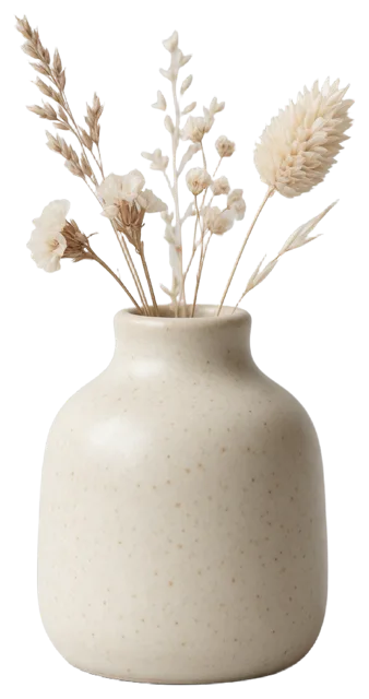 A small speckled cream ceramic vase holding a curated arrangement of dried neutral-toned flowers and grasses