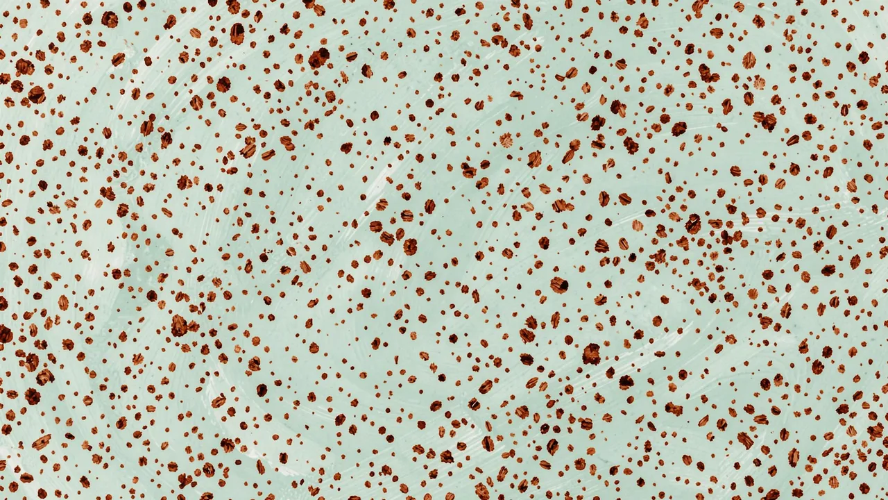 Hand-painted irregular brown speckles scattered across a pale blue-green textured surface