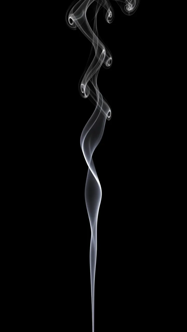 A thin vertical ribbon of white smoke rises in a lazy spiral against a solid pure black background