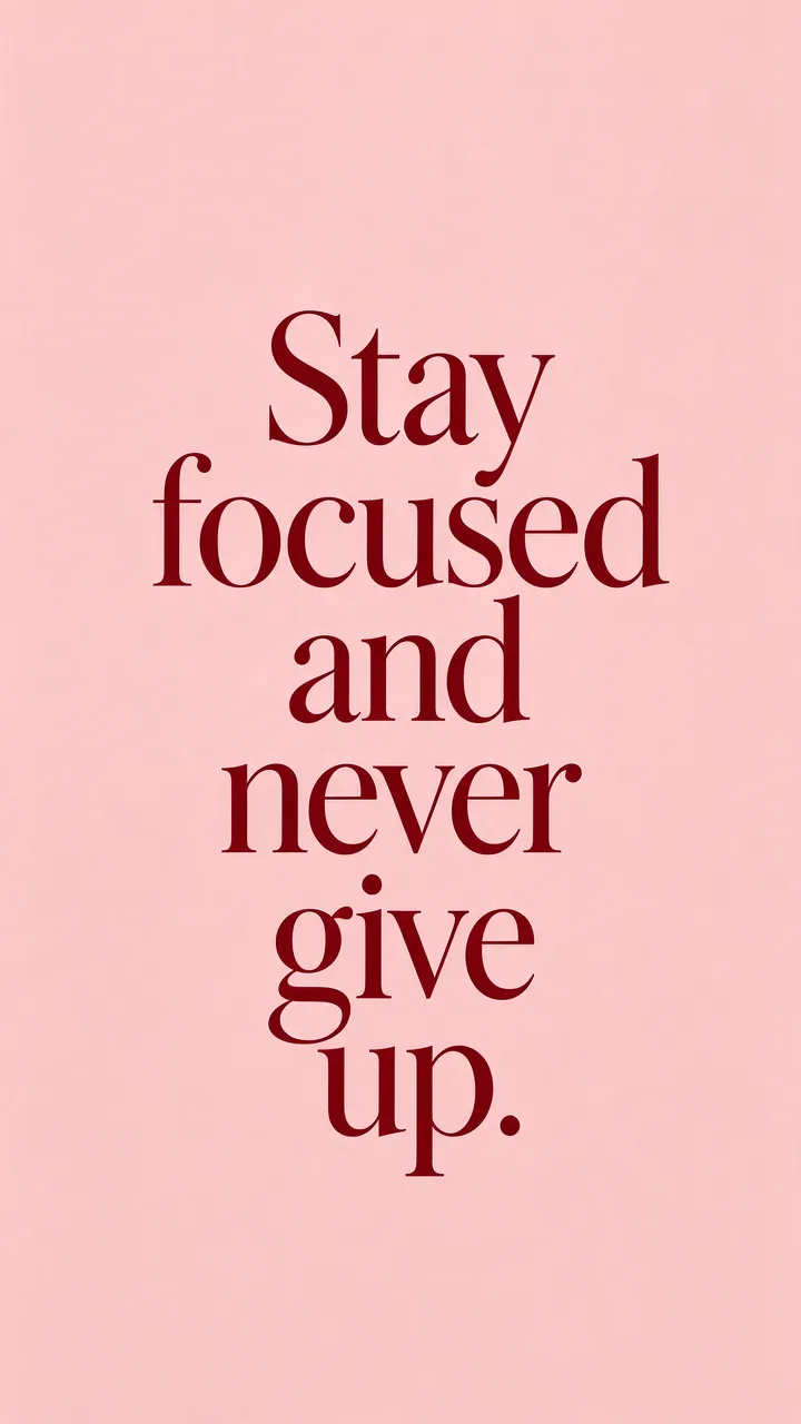 Centered deep burgundy serif text reading "Stay focused and never give up." on a soft blush pink background, formatted as a