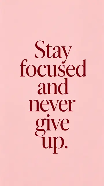 Centered deep burgundy serif text reading "Stay focused and never give up." on a soft blush pink background, formatted as a