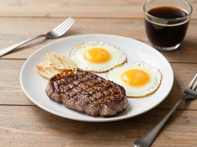 A plated steak and eggs breakfast with black coffee sits on a rustic wooden table.