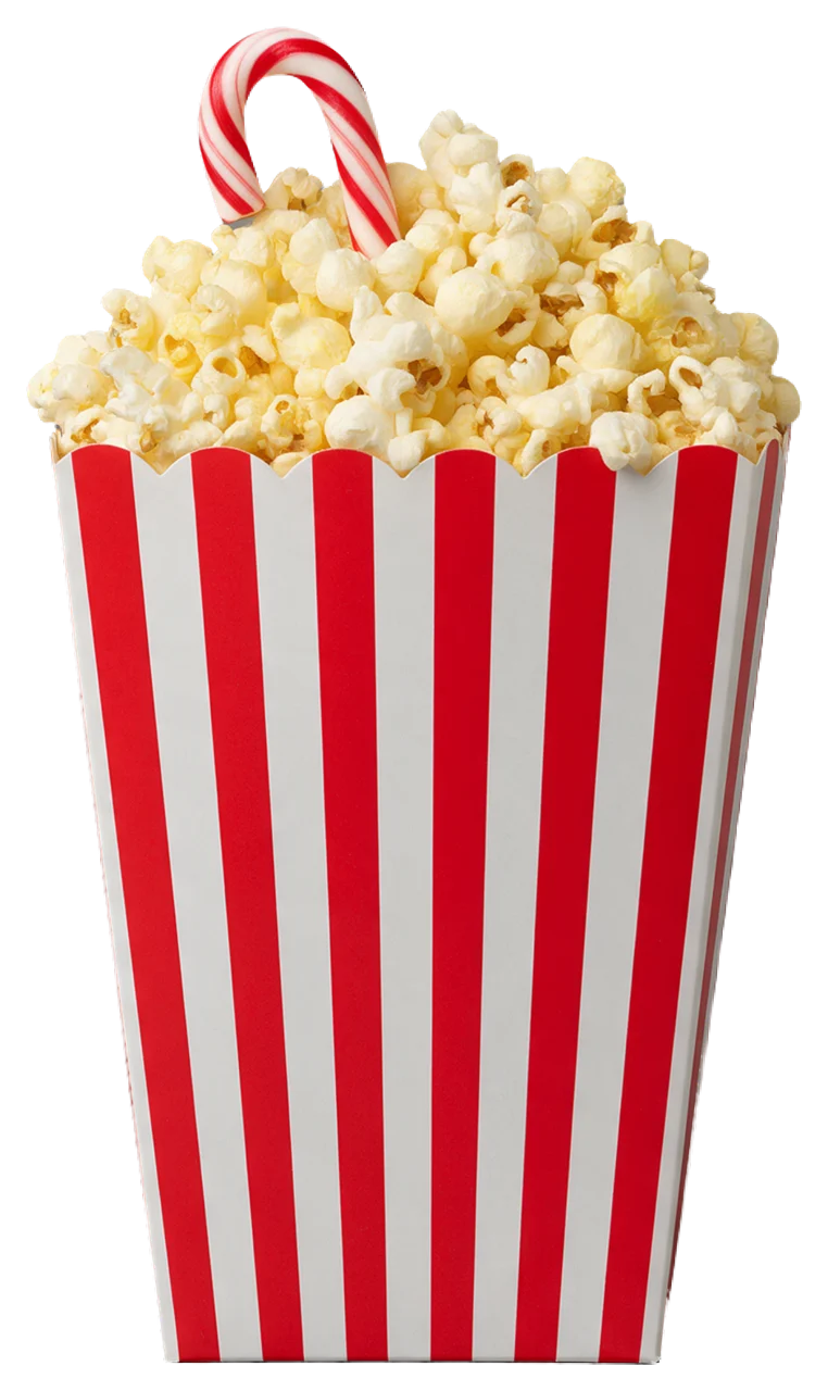Red and white striped popcorn bucket overflowing with popcorn and a tucked candy cane