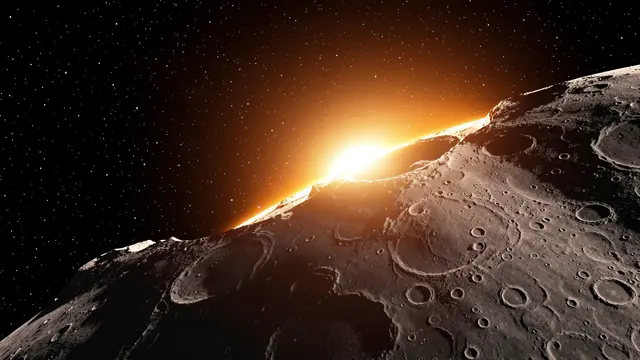 Bright sun rises above the cratered lunar horizon seen from orbit against a starry space backdrop