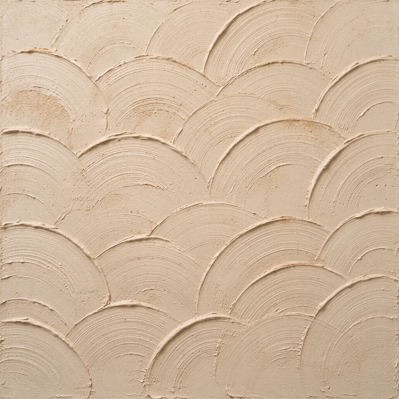 Full frame close-up of overlapping raised half-circle brush arcs on gritty beige drywall mud