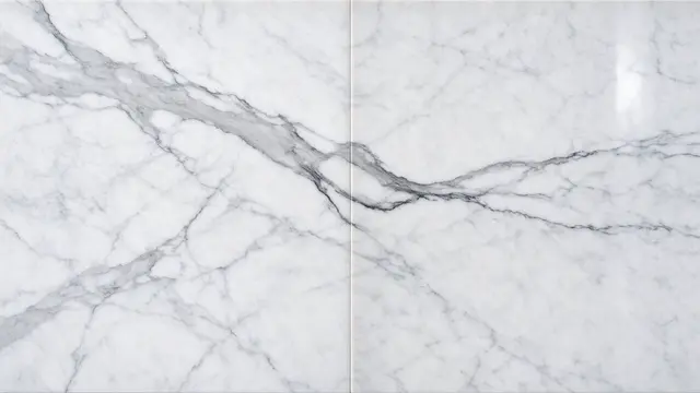 Mirror-matched white marble surface with soft gray veining running along a central seam