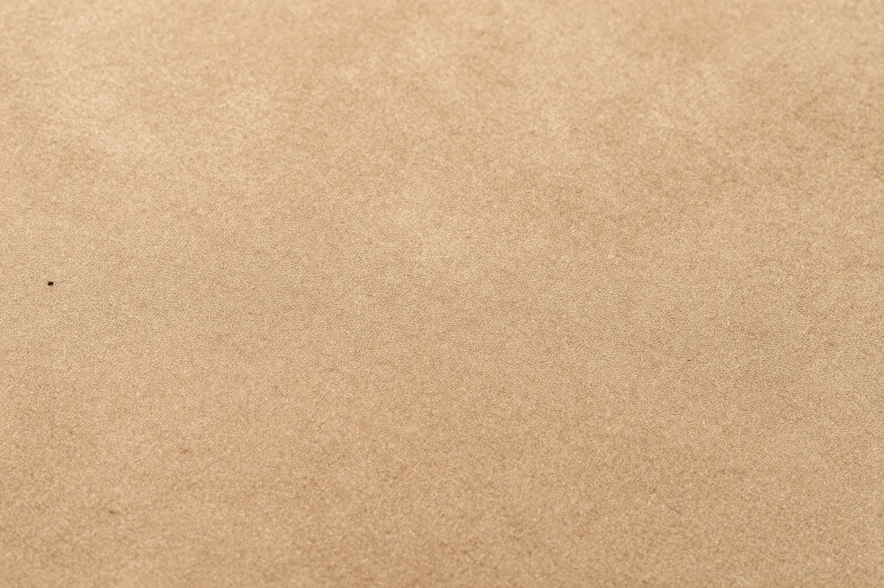 Full frame close up of soft tan suede with a fine brushed nap texture
