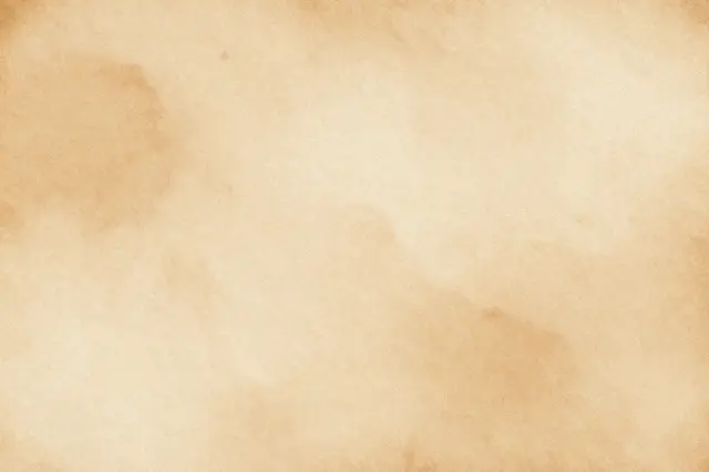 Soft aged paper surface with warm light brown tea-stained blotches across the frame
