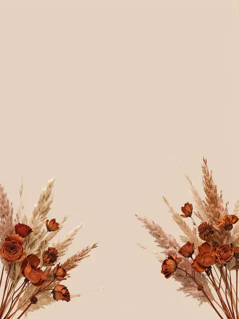 Dried terracotta flowers and pampas grass placed in opposite bottom corners of a plain beige background