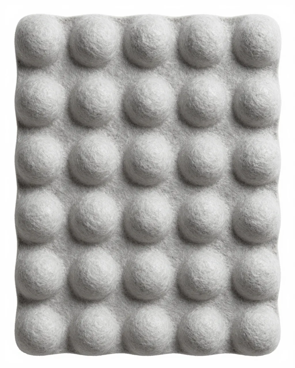 Close-up full frame of molded gray paper pulp with evenly spaced soft rounded raised bumps