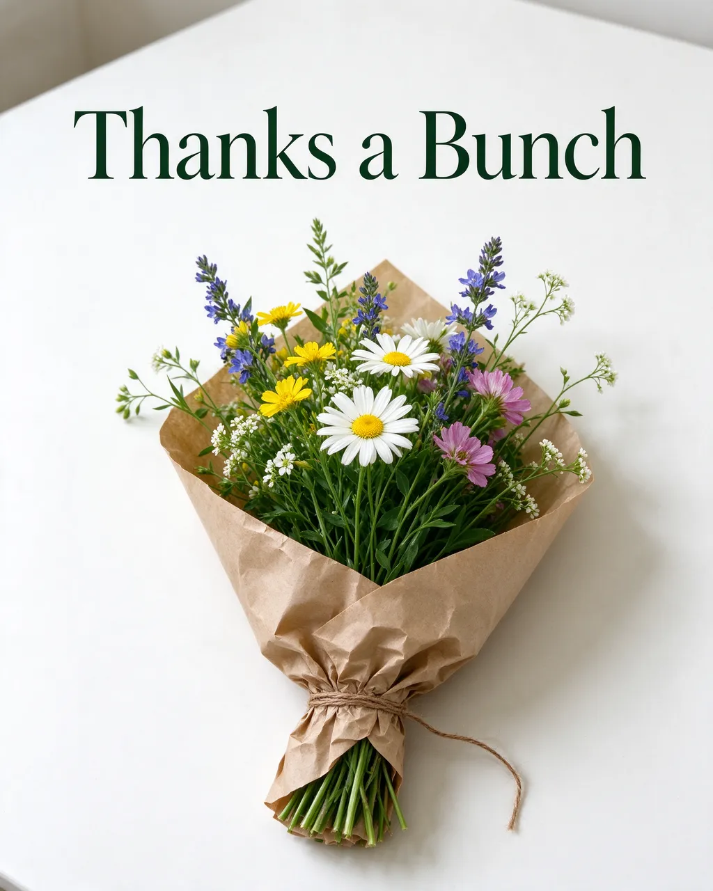 A wildflower bouquet wrapped in brown kraft paper sits below dark green serif text reading "Thanks a Bunch" on a white table.