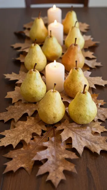 A centerpiece of oak leaves, pears and lit candles sits on a dark wooden dining table.