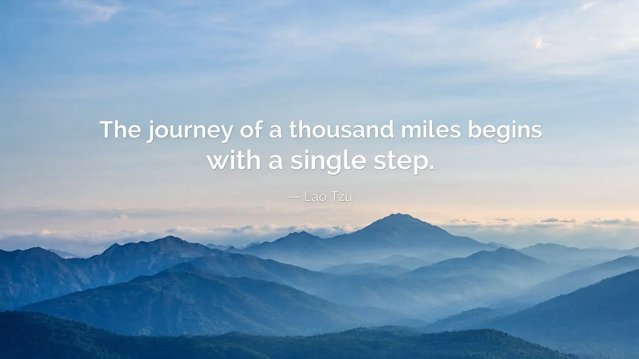 Dawn misty blue mountain range with the quote "The journey of a thousand miles begins with a single step" overlaid in white