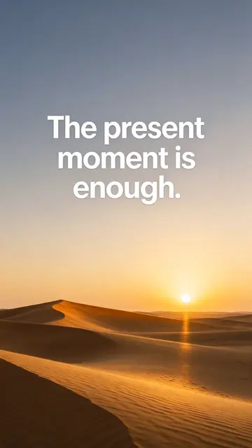 Sunset over golden desert dunes with white text reading "The present moment is enough." as a phone wallpaper
